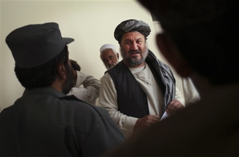 The new Arghandab district chief Shah Mohammad Ahmadi speaks with an Afghan National Police officer following a security briefing at the district headquarters in the volatile Arghandab Valley near Kandahar City, Afghanistan. 
